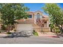 Charming two-story home with a well-maintained front yard and a two-car garage on a sunny day at 2057 Wandering Doe Ln, Las Vegas, NV 89134