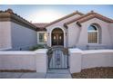 Inviting front entrance featuring a gated courtyard, a tiled roof, and double front doors at 2099 Mountain City St, Henderson, NV 89052