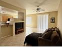 Inviting living room featuring tile flooring, a ceiling fan, and sliding glass doors for natural light at 23 E Agate Ave # 403, Las Vegas, NV 89123