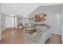 Open living room featuring vaulted ceilings, hardwood floors, and neutral tones at 2699 Aldonza Dr, Henderson, NV 89014