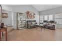 Spacious living room with hardwood floors, display case, and comfortable seating at 2699 Aldonza Dr, Henderson, NV 89014
