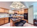 Functional kitchen equipped with a center island, tile floors, and modern appliances at 2708 Campo Verde Dr, Las Vegas, NV 89121