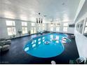 Bright indoor pool area features a blue in-ground pool, lounge chair, and many windows at 2890 Belcastro St, Las Vegas, NV 89117
