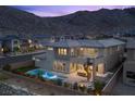 Stunning aerial view of the backyard, pool, and mountain range in the background at 2890 Reverence Heights Ln, Las Vegas, NV 89138