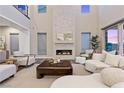 Bright living room featuring a floor to ceiling fireplace and comfortable seating at 2890 Reverence Heights Ln, Las Vegas, NV 89138