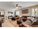 Spacious living room with tile flooring, plantation shutters, and a comfortable sectional sofa at 2958 Lapis Beach Dr, Las Vegas, NV 89117