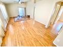 Bright living room with hardwood floors, a ceiling fan, and sliding glass doors to the patio at 3372 Wayward Ct, Las Vegas, NV 89129