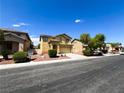 View of a two-story house with a landscaped front yard with driveway and garage at 3412 Catherine Mermet Ave, North Las Vegas, NV 89081