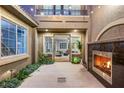Inviting courtyard with outdoor fireplace and string lights, perfect for entertaining at 3535 Coventry Gardens Dr, Las Vegas, NV 89135