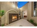 Relaxing courtyard featuring an outdoor fireplace and view to interior at 3535 Coventry Gardens Dr, Las Vegas, NV 89135