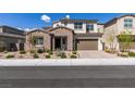 Charming two-story home with a well-manicured lawn, complemented by its beautiful stone accents and an inviting entrance at 365 Malpaso St, Las Vegas, NV 89138