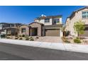 Charming two-story home with a well-manicured lawn, complemented by its beautiful stone accents and an inviting entrance at 365 Malpaso St, Las Vegas, NV 89138