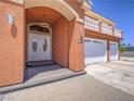 Close-up of the front entrance featuring double doors, an arched entryway, and a second-story balcony above the garage at 420 Dakar St, Henderson, NV 89015