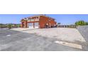 Expansive view of the terracotta house showing the large parking area, gated access, and spacious surroundings at 420 Dakar St, Henderson, NV 89015
