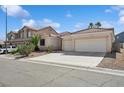 Lovely single-story home with desert landscaping, a three-car garage and a spacious driveway at 4323 Village Spring St, Las Vegas, NV 89147