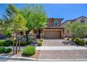 Charming home with a well-maintained lawn, mature trees, and a welcoming two-car garage at 462 Fortissimo St, Henderson, NV 89011