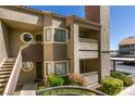 Multi-story condo building featuring private balconies and landscaped walkway to unit's entry door at 5032 S Rainbow Blvd # 206, Las Vegas, NV 89118
