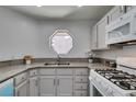 Bright kitchen featuring granite countertops, modern appliances, and a large octagonal window at 5032 S Rainbow Blvd # 206, Las Vegas, NV 89118