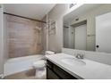 Bathroom featuring a shower-over-tub combo, modern fixtures, and a vanity with a solid surface countertop at 698 S Racetrack Rd # 114, Henderson, NV 89015