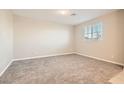 Bright bedroom features plush carpeting, neutral paint, and a large window for natural light at 762 Star Estates Ave # 0, North Las Vegas, NV 89086
