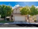 Inviting two-story home featuring a well-manicured lawn and mature trees providing shade and curb appeal at 7837 Fort Ruby Pl, Las Vegas, NV 89128