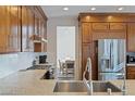 Modern kitchen showcasing stainless steel appliances, granite countertops, and custom cabinets at 7837 Fort Ruby Pl, Las Vegas, NV 89128