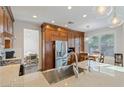 Modern kitchen showcasing stainless steel appliances, granite countertops, and custom cabinets at 7837 Fort Ruby Pl, Las Vegas, NV 89128