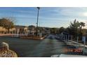 Community entrance with guard gate and mountain views in background at 7934 Cape Flattery Ave, Las Vegas, NV 89147