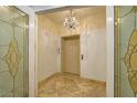 Elevator with decorative glass doors and chandelier, offering a glimpse of sophisticated design and functionality at 9101 Alta Dr # 1203, Las Vegas, NV 89145