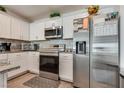 Kitchen with stainless steel appliances, white cabinets, and granite countertops at 12110 Midnight Pine Rd # 4, Las Vegas, NV 89183