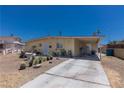 Charming single-story home with a long driveway, mature landscaping, and a well-maintained front yard at 1312 Denarius Cir, Las Vegas, NV 89101