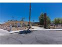 Charming single-story home with a long driveway, mature landscaping, and a well-maintained front yard at 1312 Denarius Cir, Las Vegas, NV 89101