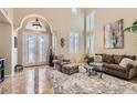 Bright living room with high ceilings, large windows, and a stylish seating arrangement, perfect for relaxation at 1667 Sabatini Dr, Henderson, NV 89052