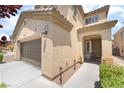 Two-story home featuring a two car garage, neutral color palette, and manicured landscaping at 190 Tall Ruff Dr, Las Vegas, NV 89148