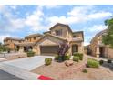 Two-story home featuring a two car garage, neutral color palette, and low maintenance landscaping at 190 Tall Ruff Dr, Las Vegas, NV 89148