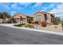 Attractive single story home featuring a three car garage and colorful, low-water landscaping at 2175 Sandstone Cliffs Dr, Henderson, NV 89044