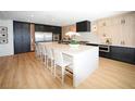 Spacious kitchen boasts a large island with seating, stainless steel appliances, and contrasting black and light wood cabinetry at 2736 Botticelli Dr, Henderson, NV 89052