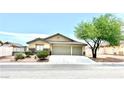 Charming single-story home featuring a three-car garage, desert landscaping, and a cozy, inviting facade at 3125 Prairie Princess Ave, North Las Vegas, NV 89081