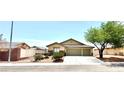 Charming single-story home featuring a three-car garage, desert landscaping, and a cozy, inviting facade at 3125 Prairie Princess Ave, North Las Vegas, NV 89081