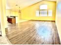 Spacious living room showcasing light-colored walls, high ceilings, and wood-look tile flooring at 3125 Prairie Princess Ave, North Las Vegas, NV 89081