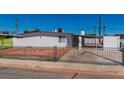 Exterior view of a well-maintained, white home with a secure gated front yard at 3212 Hickey Ave, North Las Vegas, NV 89030