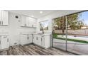 Modern kitchen with sleek white cabinets, countertops, and stainless steel appliances at 4046 Bridgeview Cir, Las Vegas, NV 89147