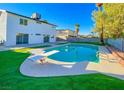 Lush backyard with a refreshing swimming pool and diving board, ideal for summer fun at 4046 Bridgeview Cir, Las Vegas, NV 89147