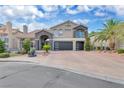 Stunning two-story home with a well-manicured yard, circular driveway, and a two-car garage at 4108 Royal Scots Ave, Las Vegas, NV 89141