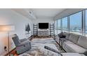Cozy living room with city views, features neutral decor and modern entertainment center at 4525 Dean Martin Dr # 1208, Las Vegas, NV 89103