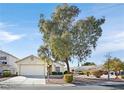 Charming single-story home with a well-maintained front yard and mature shade tree at 5429 Sweet Shade St, Las Vegas, NV 89130