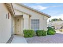 Close up of the home's exterior showing a front door, window, and manicured landscaping at 5429 Sweet Shade St, Las Vegas, NV 89130