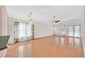 Spacious living room featuring wood floors, neutral paint, chandelier, and lots of natural light at 5429 Sweet Shade St, Las Vegas, NV 89130