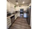 Updated kitchen with stainless steel appliances, granite countertops and white cabinetry at 5591 La Perla Ct, Las Vegas, NV 89122
