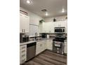 Updated kitchen with stainless steel appliances, granite countertops and white cabinetry at 5591 La Perla Ct, Las Vegas, NV 89122